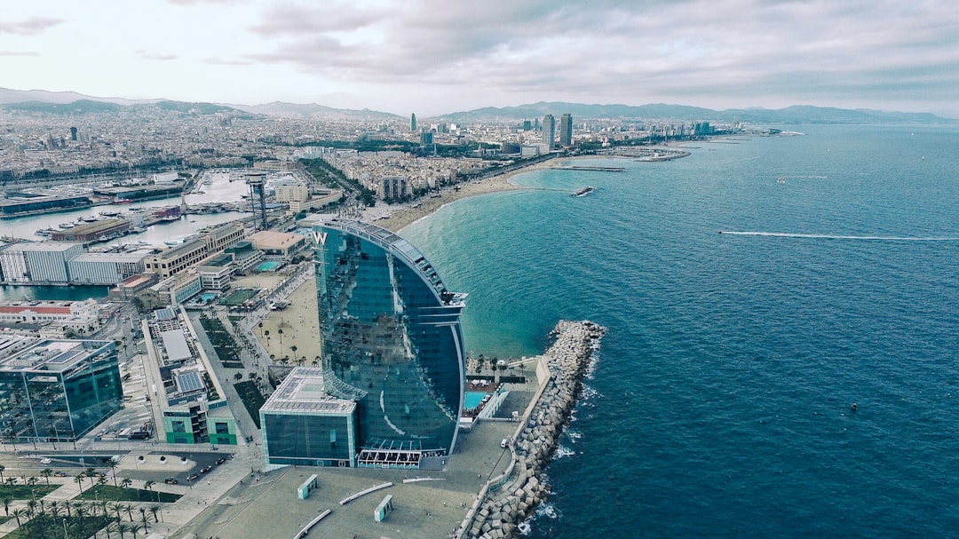 clear glass building near sea under grey sky — Foto: Benjamín Gremler / Unsplash